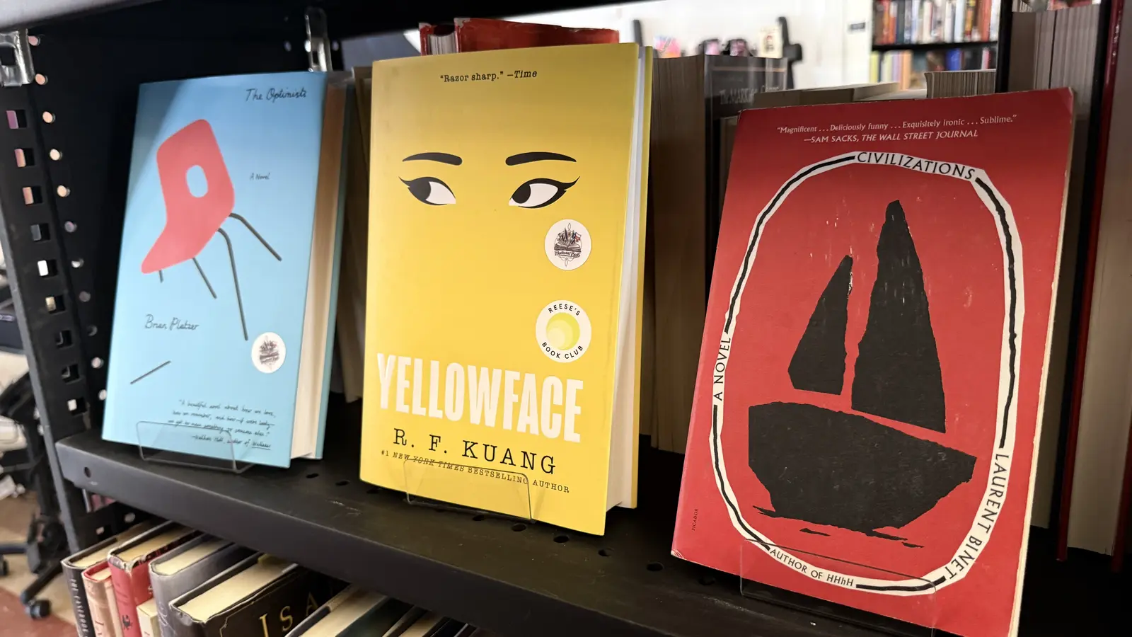 Fiction shelf featuring Yellowface by R. F. Kuang, The Optimists, and Civilizations.