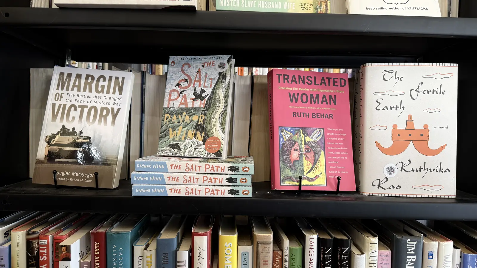 Nonfiction shelf featuring Margin of Victory, The Salt Path by Raynor Winn, and Translated Woman.