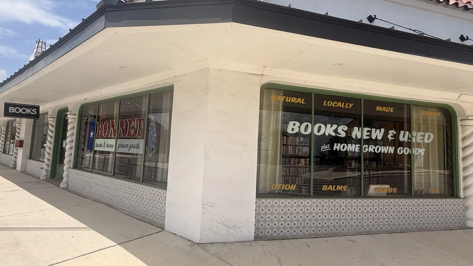 Corner view of the Books New & Used and Home Grown Goods window signage.